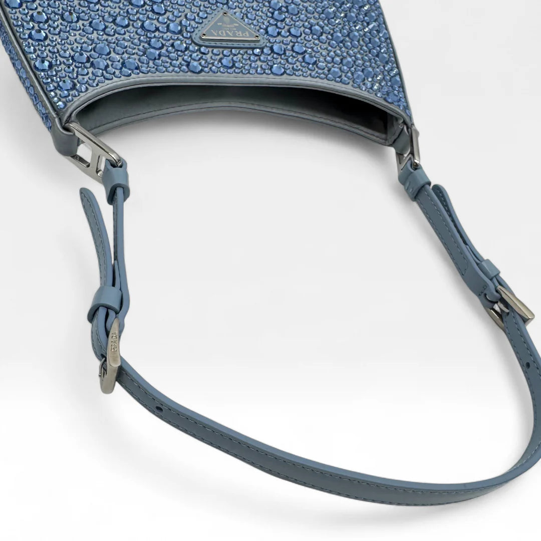 https://cdn.shopify.com/s/files/1/0564/9376/8855/files/Prada_Handtasche_Cleo_Kristall_aus_Nylon_hellblau_handbag5076_a1ad1bad-17e6-473f-be54-33d170b80b82.webp?v=1761263458