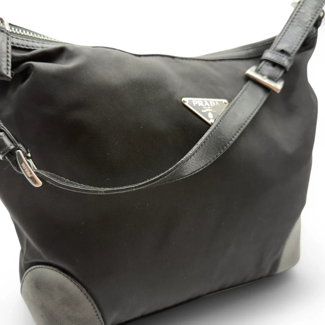 https://cdn.shopify.com/s/files/1/0564/9376/8855/files/Prada_Handtasche_Halbmond_Form_schwarze_Lederecken_Nylon_schwarz_vintage_designer_handbag_4208.webp?v=1741796308