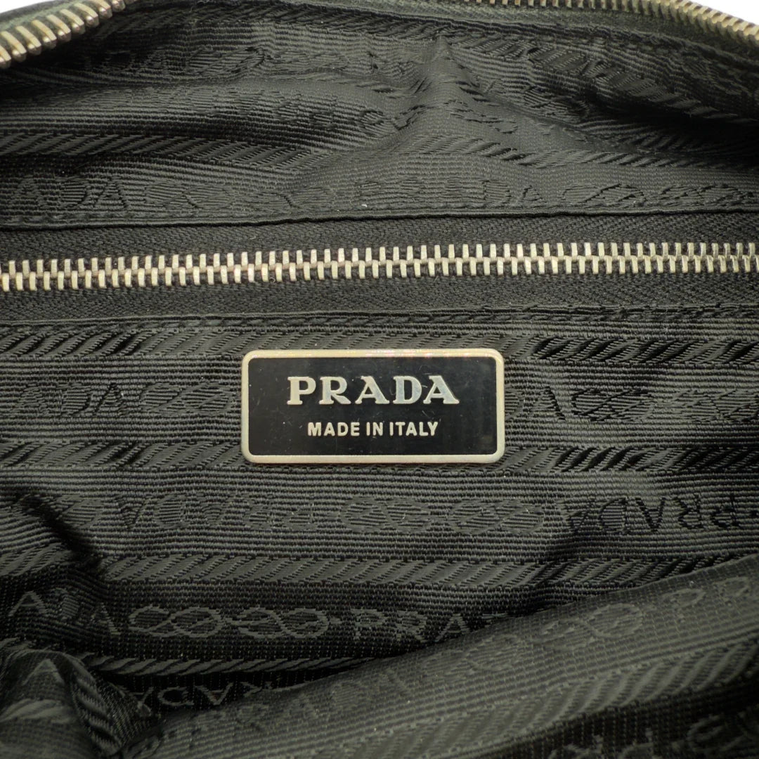 https://cdn.shopify.com/s/files/1/0564/9376/8855/files/Prada_Handtasche_Halbmond_Form_schwarze_Lederecken_Nylon_schwarz_vintage_designer_handbag_4210.webp?v=1741796308