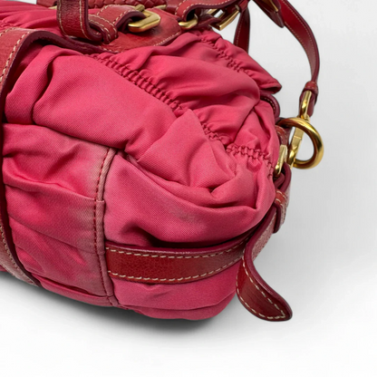 https://cdn.shopify.com/s/files/1/0564/9376/8855/files/Prada_Handtasche_Pocono_aus_Nylon_pink_second_hand_designer_handbag3388.webp?v=1757505483