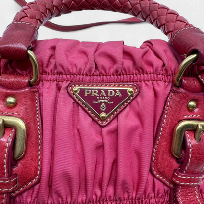 https://cdn.shopify.com/s/files/1/0564/9376/8855/files/Prada_Handtasche_Pocono_aus_Nylon_pink_second_hand_designer_handbag3393.webp?v=1757505484