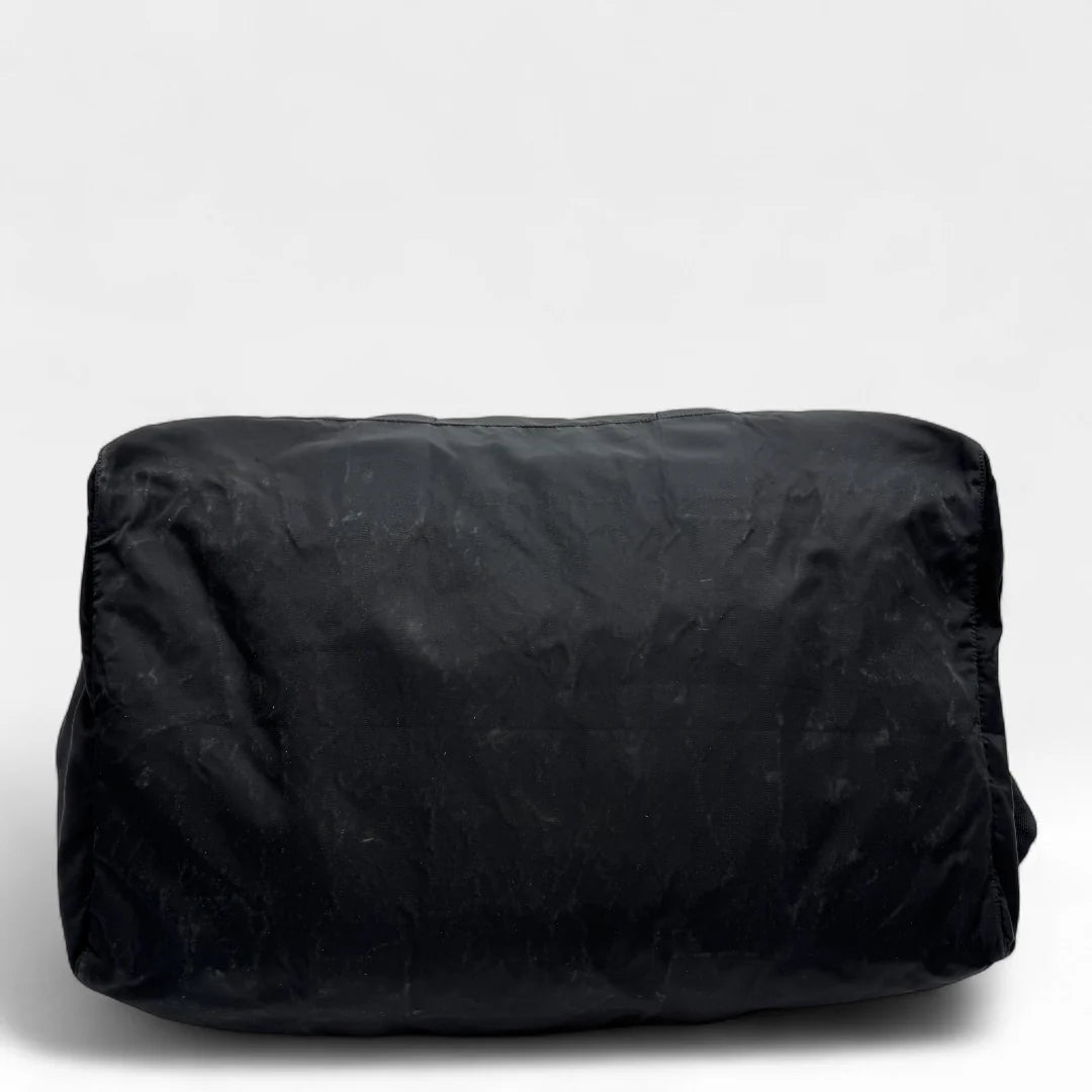 https://cdn.shopify.com/s/files/1/0564/9376/8855/files/Prada_Reisetasche_50_aus_Nylon_schwarz_vintage_dufflebag5152.webp?v=1761262441