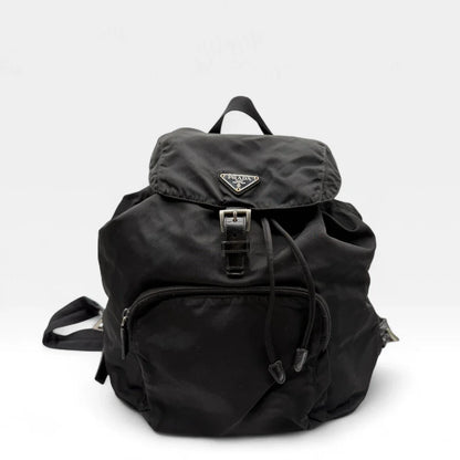 https://cdn.shopify.com/s/files/1/0564/9376/8855/files/Prada_Rucksack_mit_Schnalle_aus_Nylon_schwarz_second_hand_designer_backpack3154.webp?v=1753348302