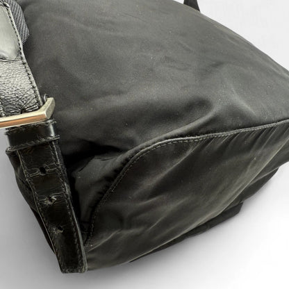 https://cdn.shopify.com/s/files/1/0564/9376/8855/files/Prada_Rucksack_mit_Schnalle_aus_Nylon_schwarz_second_hand_designer_backpack3163.webp?v=1753348226
