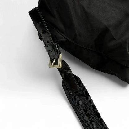 https://cdn.shopify.com/s/files/1/0564/9376/8855/files/Prada_Rucksack_mit_Schnalle_aus_Nylon_schwarz_second_hand_designer_backpack3167.webp?v=1753348226