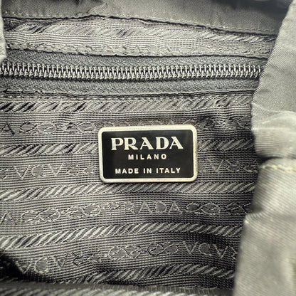 https://cdn.shopify.com/s/files/1/0564/9376/8855/files/Prada_Rucksack_mit_Schnalle_aus_Nylon_schwarz_second_hand_designer_backpack3174.webp?v=1753348227