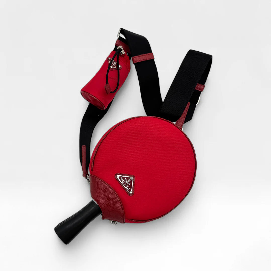 https://cdn.shopify.com/s/files/1/0564/9376/8855/files/Prada_Tischtennisschlager_mit_Umhangetasche_und_Ballen5087.webp?v=1761264011