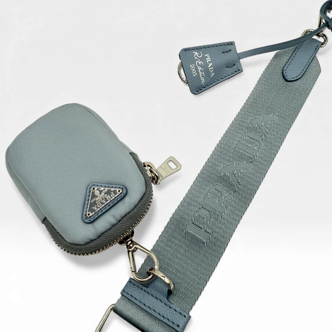 https://cdn.shopify.com/s/files/1/0564/9376/8855/files/Prada_Umhangetasche_Tessuto_Re-Nylon_2005_hellblau_crossbody_5837.webp?v=1765453661