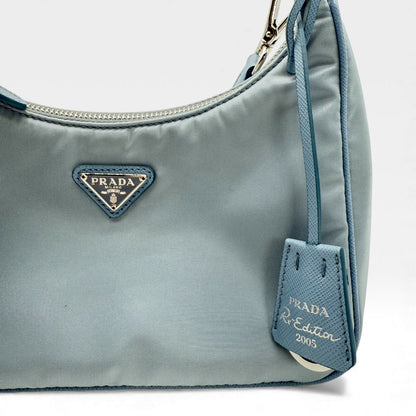 https://cdn.shopify.com/s/files/1/0564/9376/8855/files/Prada_Umhangetasche_Tessuto_Re-Nylon_2005_hellblau_crossbody_5838.webp?v=1765453661