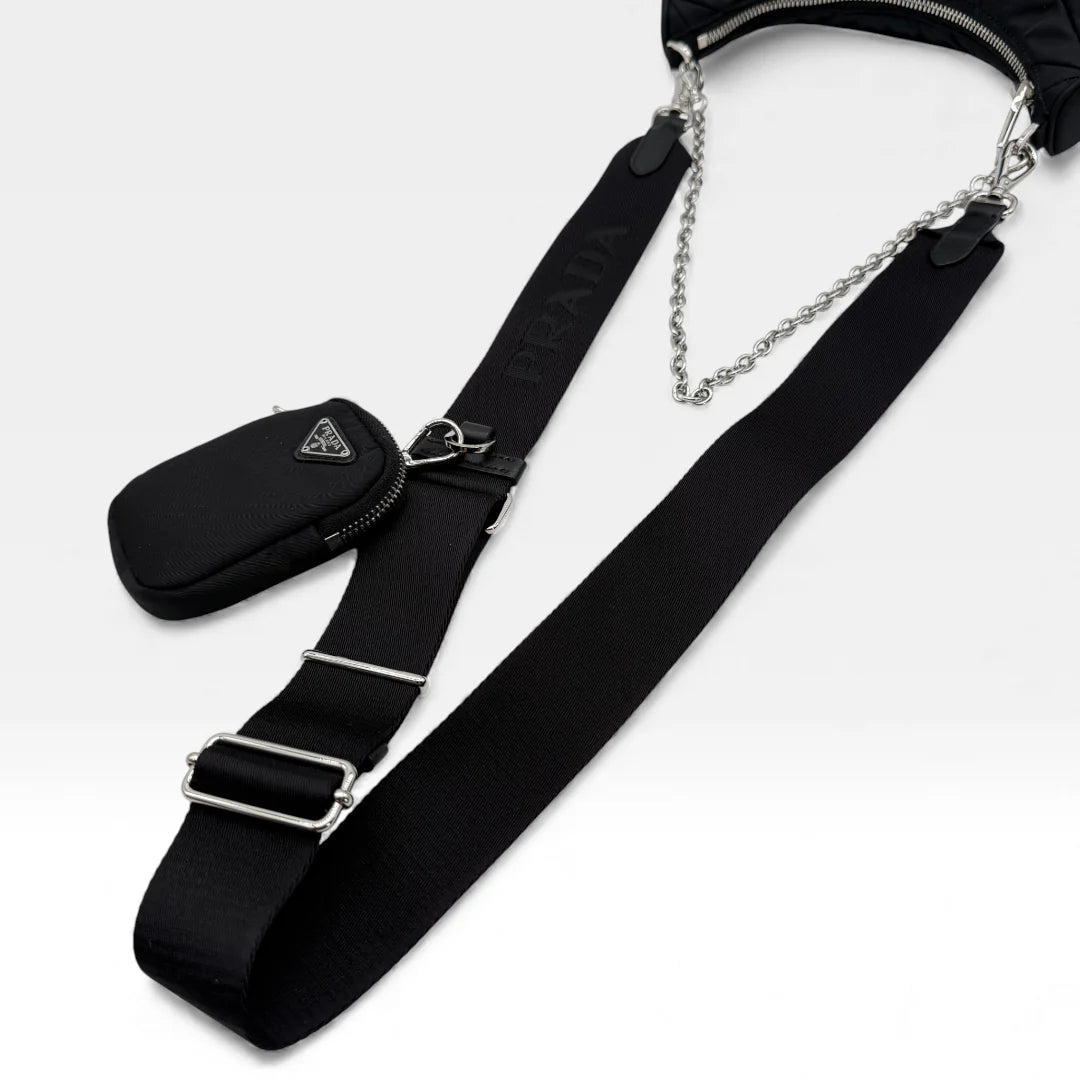https://cdn.shopify.com/s/files/1/0564/9376/8855/files/Prada_Umhangetasche_Tessuto_Stepp_aus_Nylon_schwarz_vintage_crossbody_5816.webp?v=1765452267