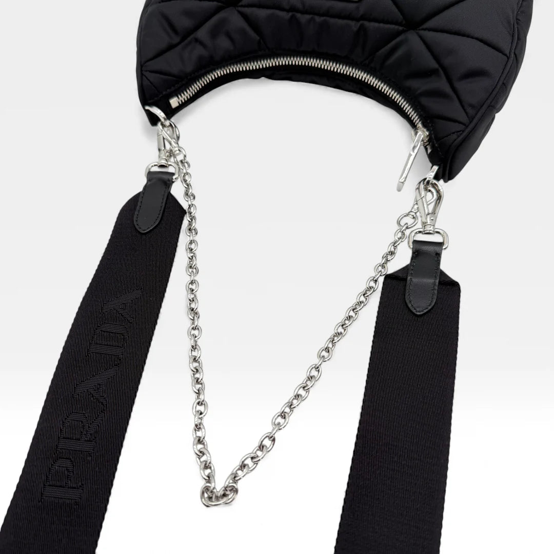 https://cdn.shopify.com/s/files/1/0564/9376/8855/files/Prada_Umhangetasche_Tessuto_Stepp_aus_Nylon_schwarz_vintage_crossbody_5818.webp?v=1765452267