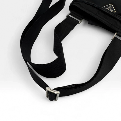https://cdn.shopify.com/s/files/1/0564/9376/8855/files/Prada_Umhangetasche_basic_aus_Nylon_schwarz_vintage_luxury_crossbody3008.webp?v=1757027939