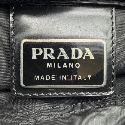 https://cdn.shopify.com/s/files/1/0564/9376/8855/files/Prada_Umhangetasche_basic_small_aus_Nylon_schwarz_vintage8300.webp?v=1781084673