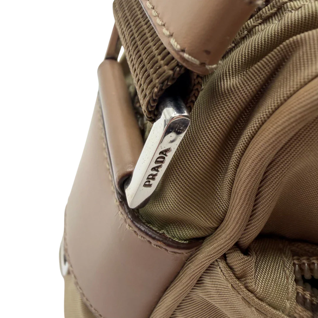 https://cdn.shopify.com/s/files/1/0564/9376/8855/files/Prada_Umhangetasche_rechteckig_small_aus_Nylon_hellbraun_13.webp?v=1782311805