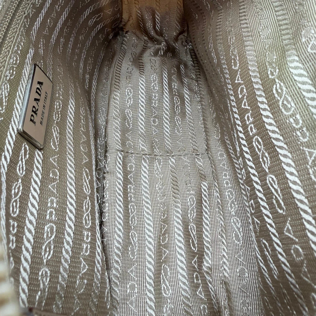 https://cdn.shopify.com/s/files/1/0564/9376/8855/files/Prada_Umhangetasche_rechteckig_small_aus_Nylon_hellbraun_14.webp?v=1782311805