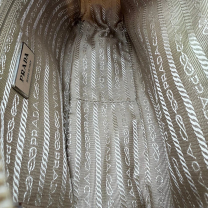https://cdn.shopify.com/s/files/1/0564/9376/8855/files/Prada_Umhangetasche_rechteckig_small_aus_Nylon_hellbraun_14.webp?v=1782311805