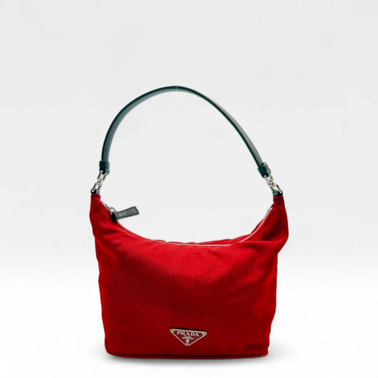 https://cdn.shopify.com/s/files/1/0564/9376/8855/files/Prada__Handtasche__aus__Nylon__rot__vintage__designer__handbag6863.webp?v=1749059824