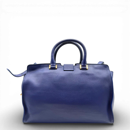 https://cdn.shopify.com/s/files/1/0564/9376/8855/files/Saint_Laurent_Handtasche_Cabbas_mit_Umhangegurt_aus_Leder_blau_vintage2603.webp?v=1773312218