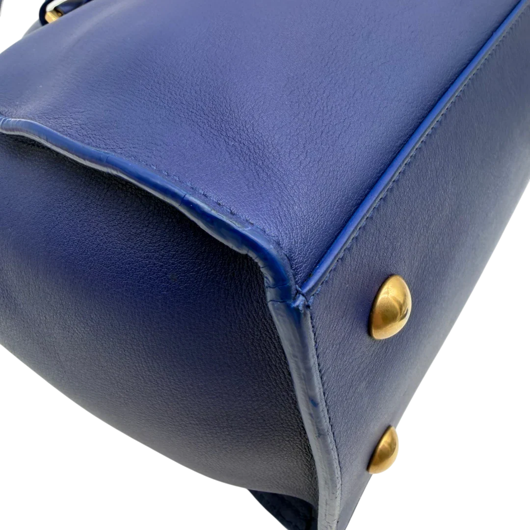 https://cdn.shopify.com/s/files/1/0564/9376/8855/files/Saint_Laurent_Handtasche_Cabbas_mit_Umhangegurt_aus_Leder_blau_vintage2608.webp?v=1773312218