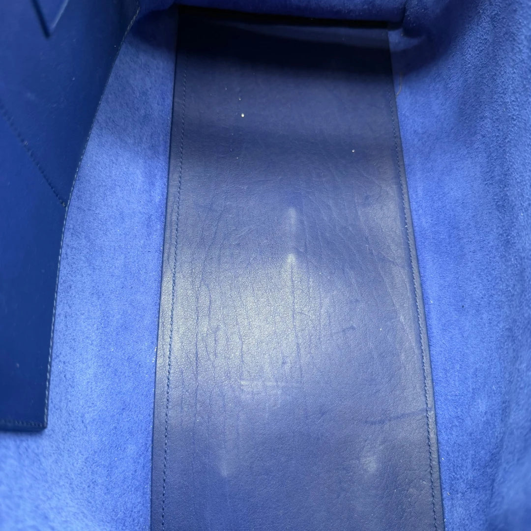 https://cdn.shopify.com/s/files/1/0564/9376/8855/files/Saint_Laurent_Handtasche_Cabbas_mit_Umhangegurt_aus_Leder_blau_vintage2615.webp?v=1773312218