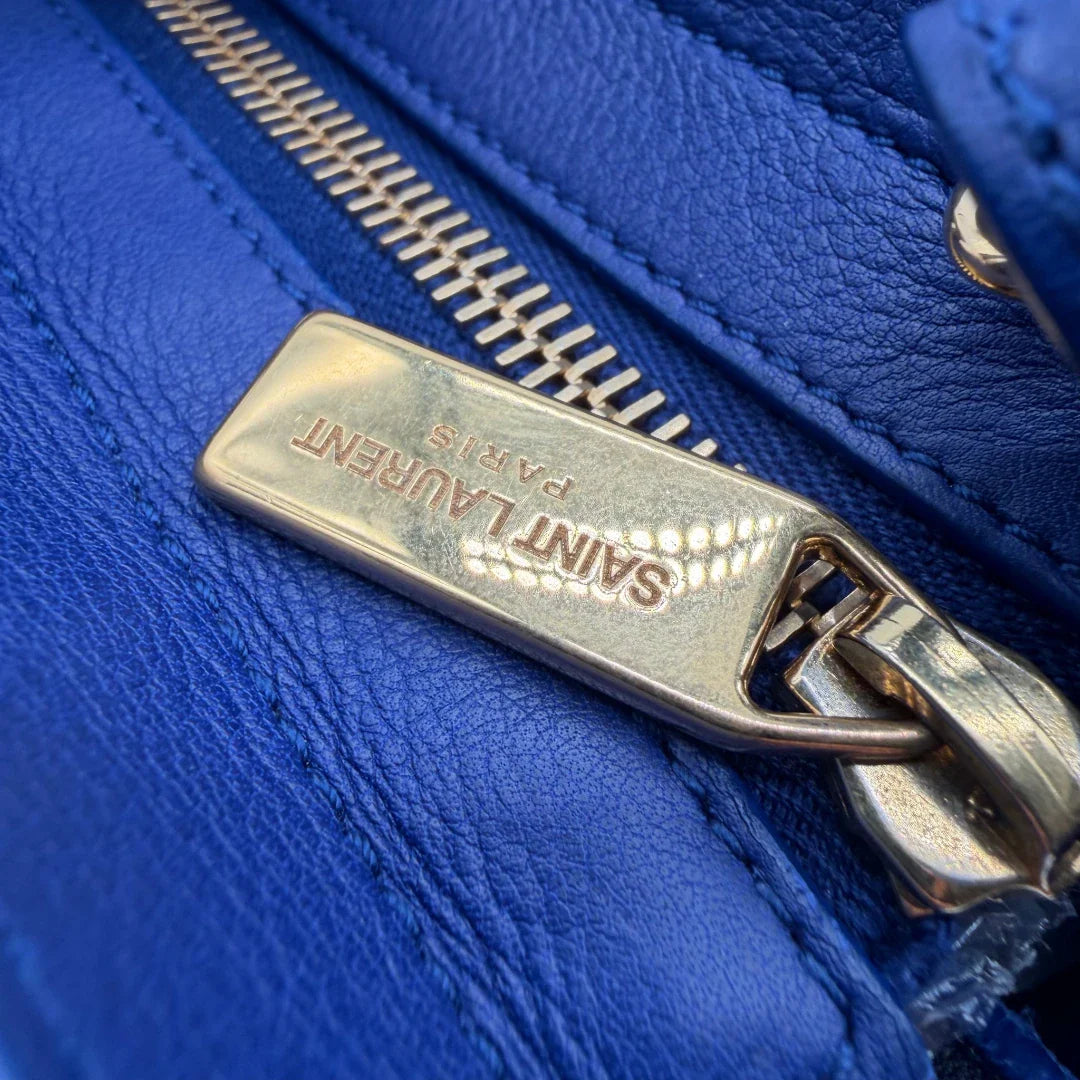 https://cdn.shopify.com/s/files/1/0564/9376/8855/files/Saint_Laurent_Handtasche_Cabbas_mit_Umhangegurt_aus_Leder_blau_vintage2619.webp?v=1773312218