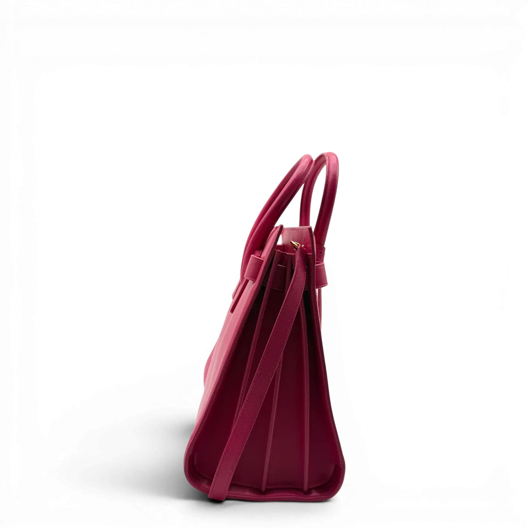 https://cdn.shopify.com/s/files/1/0564/9376/8855/files/Saint_Laurent_Handtasche_Sac_de_Jour_medium_aus_Leder_pink_vintage_YSL7101.webp?v=1779895629