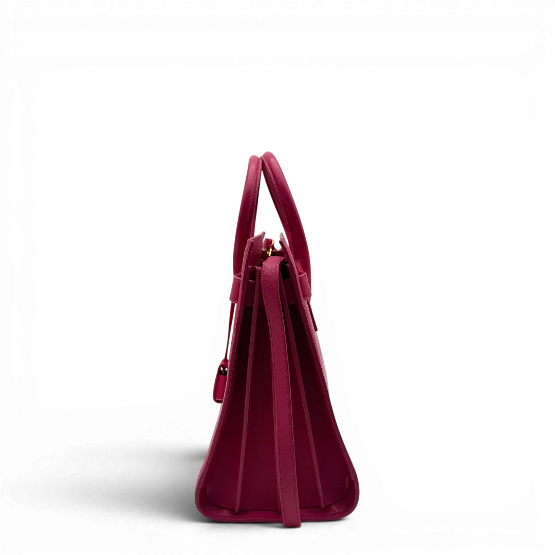 https://cdn.shopify.com/s/files/1/0564/9376/8855/files/Saint_Laurent_Handtasche_Sac_de_Jour_medium_aus_Leder_pink_vintage_YSL7102.webp?v=1779895629