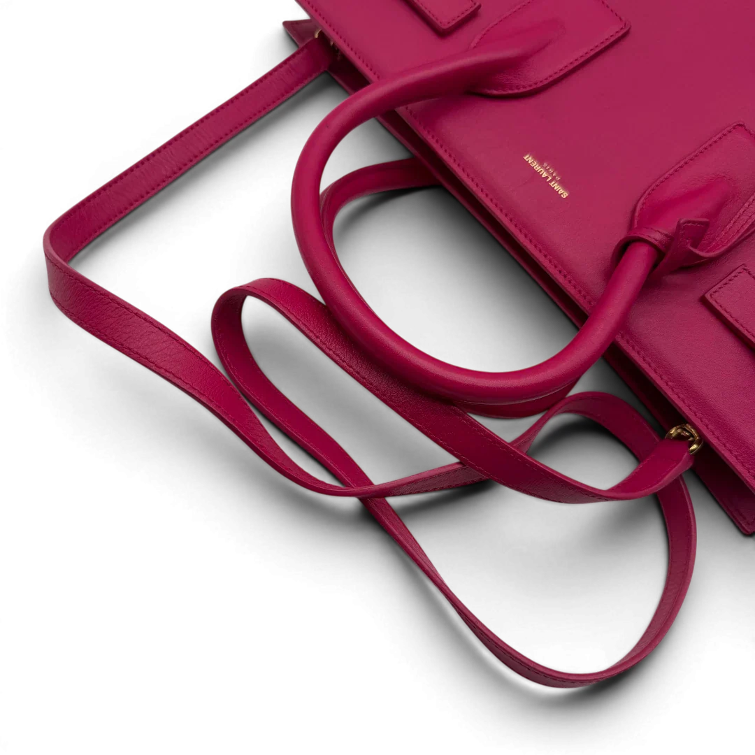 https://cdn.shopify.com/s/files/1/0564/9376/8855/files/Saint_Laurent_Handtasche_Sac_de_Jour_medium_aus_Leder_pink_vintage_YSL7108.webp?v=1779895630