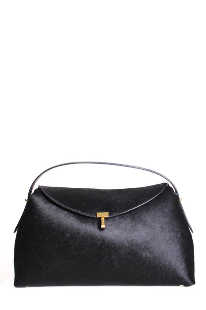 https://cdn.shopify.com/s/files/1/0770/3278/4192/files/Toteme_T_Lock_Pony_Hair_Bag_Black.jpg?v=1766441030