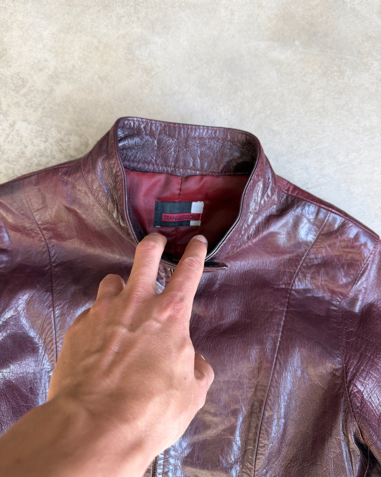 Transmission New York Oxblood Red Leather Jacket – L-on a concrete background