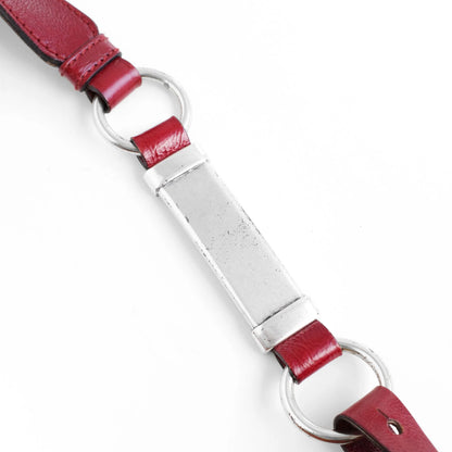 Yves Saint Laurent SS 2002 Tom Ford era red leather mombasa sling bag with a half-moon shape, chain leather strap and top zip closure. Available at Artefact Archive.