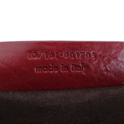 Yves Saint Laurent SS 2002 Tom Ford era red leather mombasa sling bag with a half-moon shape, chain leather strap and top zip closure. Available at Artefact Archive.