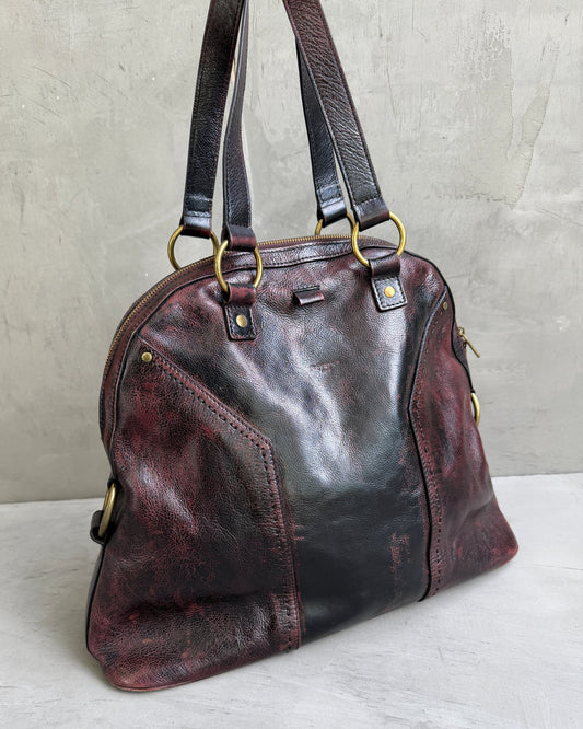 Yves Saint Laurent Leather Muse Bag-on a concrete background
