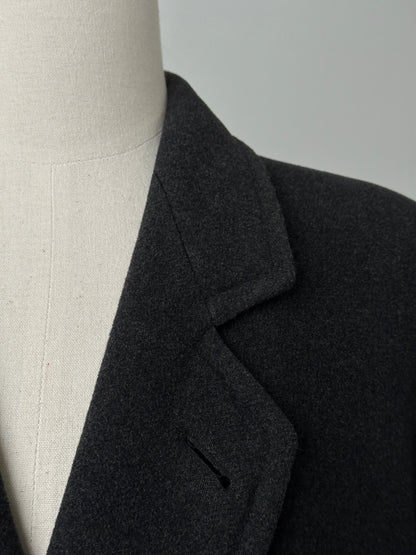 Vintage 1990s wool cashmere high neck belted coat displayed on a hanger, showcasing its classic design and rich texture.