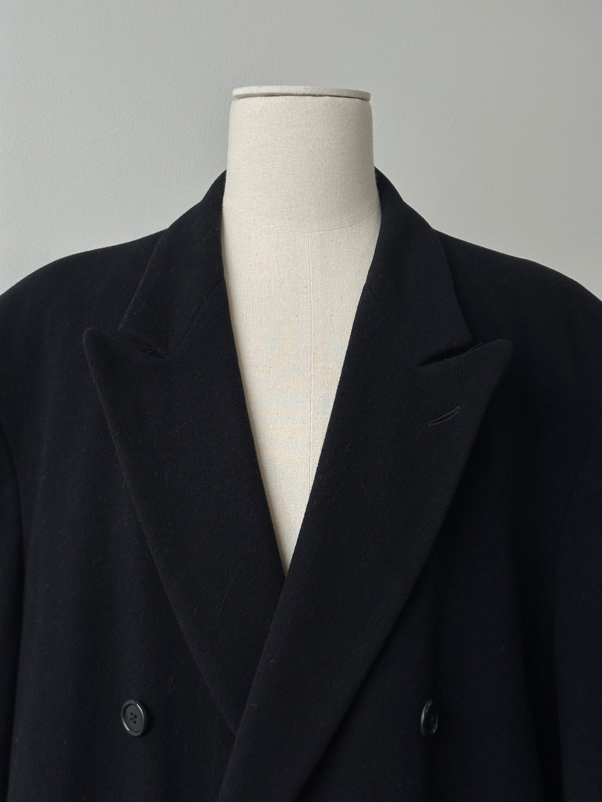 Pierre Cardin 1990s wool cashmere double-breasted coat in XXL, shown on a hanger with details of the fabric and classic design.
