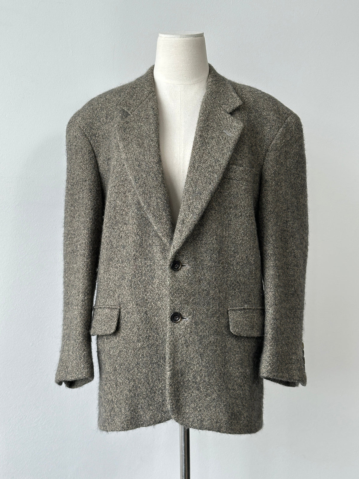 Christian Dior 1990s pure brushed wool single-breasted blazer in size S-M, shown on a hanger with a classic tailored fit.