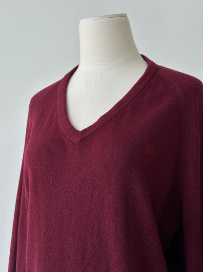 Christian Dior 1990s V-neck logo jumper in gray, featuring the iconic Dior logo on the front, displayed on a hanger.
