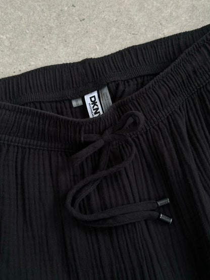 DKNY beachwear wide leg trousers in pure cotton, featuring a 2000s style, displayed in a natural pose with a neutral background.