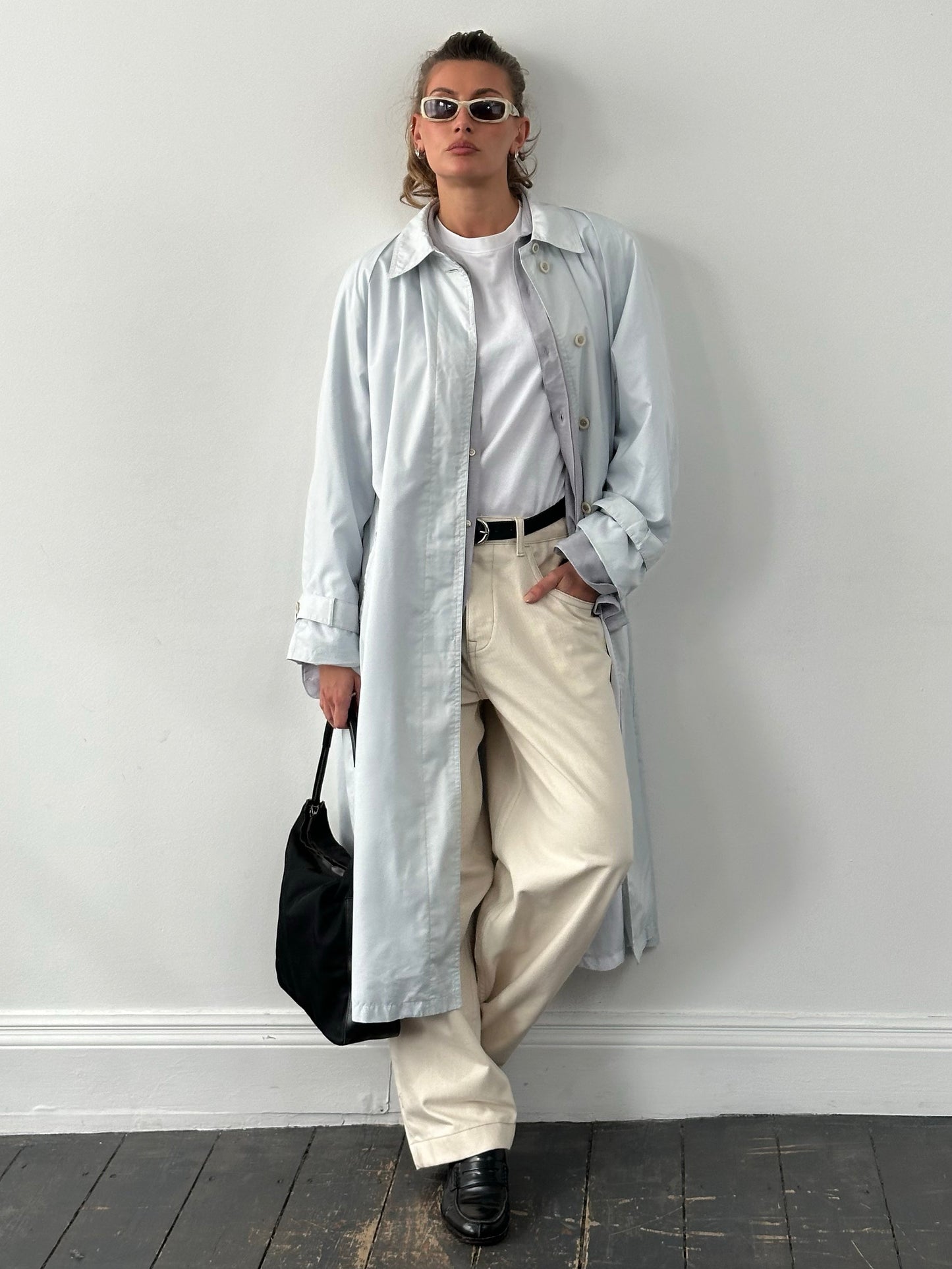 London Fog 1990s concealed placket trench coat in XL displayed on a hanger, showcasing classic beige fabric and double-breasted style.