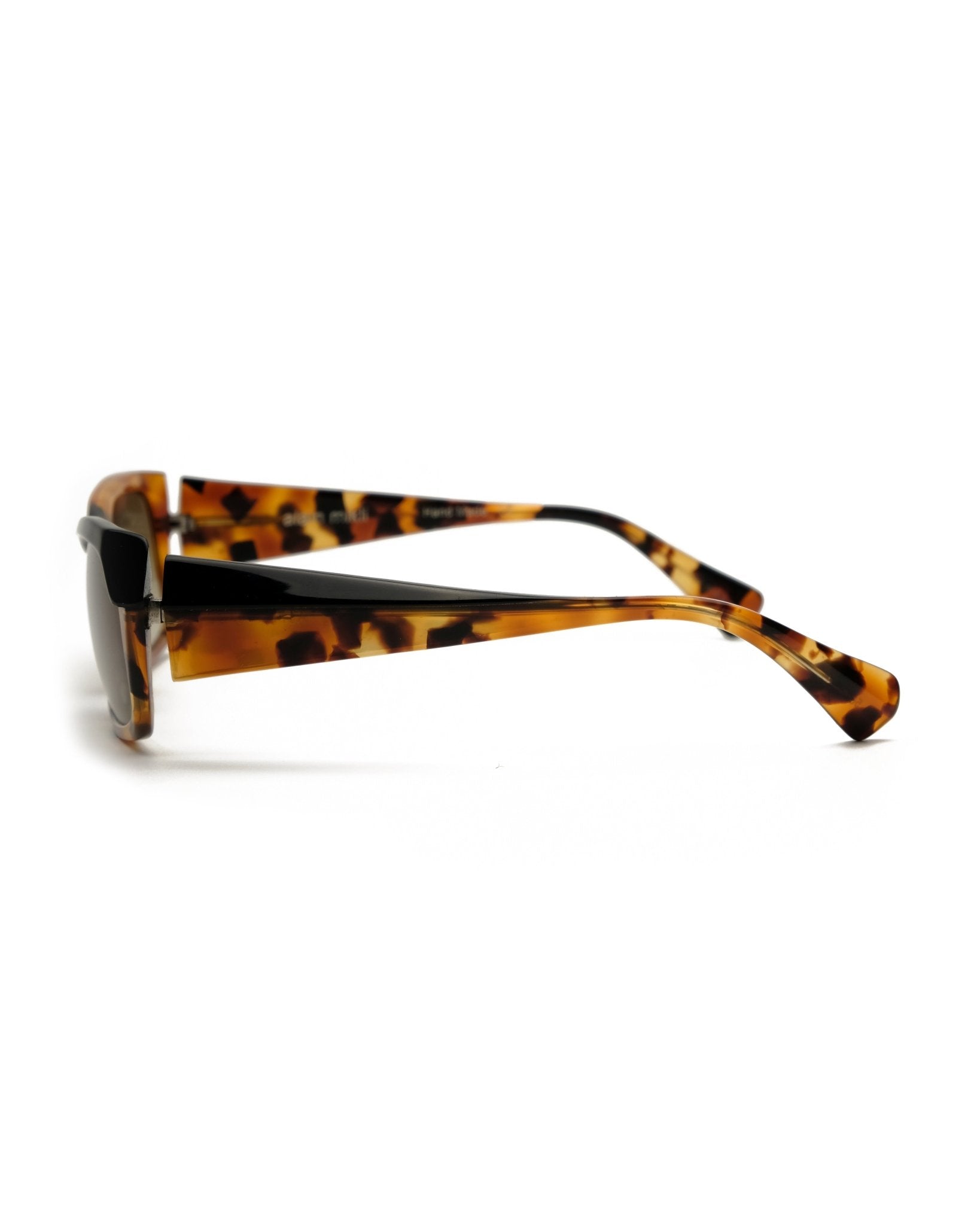 https://cdn.shopify.com/s/files/1/0818/5459/5398/files/alain-mikli-alain-mikli-asymmetrical-sunglasses-vintage-su475-1978436.jpg?v=1778953734