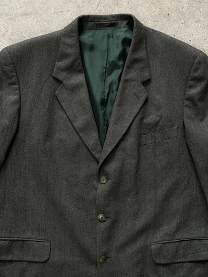 Yves Saint Laurent Pour Homme 1990s pure wool single-breasted blazer in size 46R, shown on a hanger with front view.