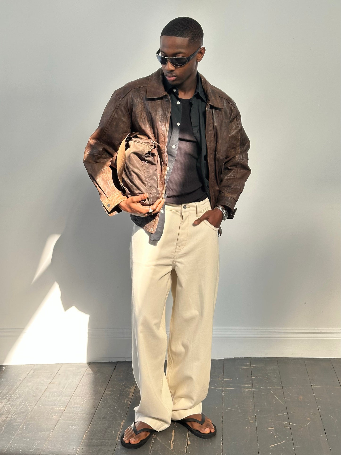 Vintage 1990s distressed leather bomber jacket, men's size M, with rugged, worn-in look and classic style.