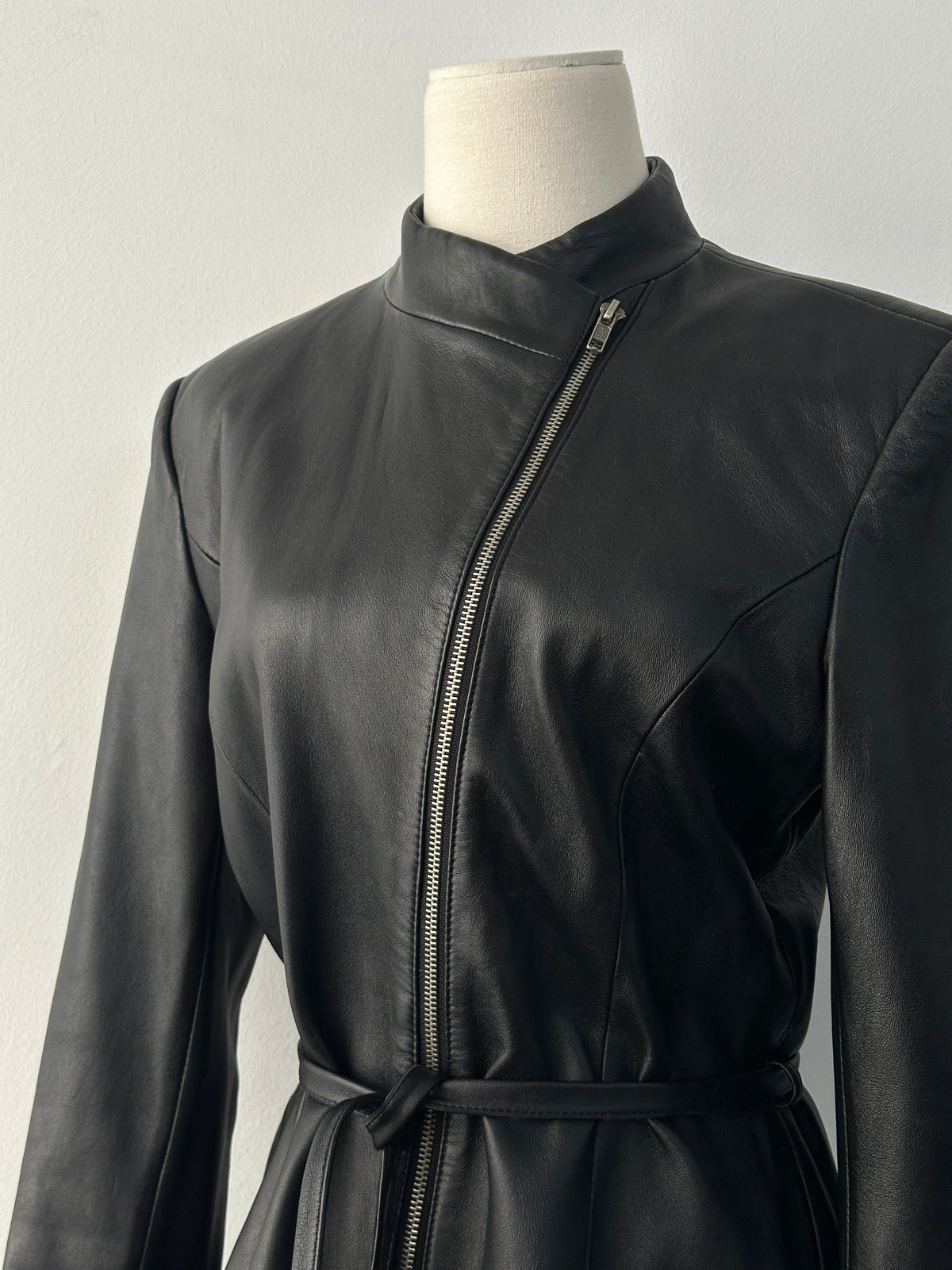 Vintage 1990s asymmetric belted leather jacket, small size, featuring classic leather texture and stylish design details.