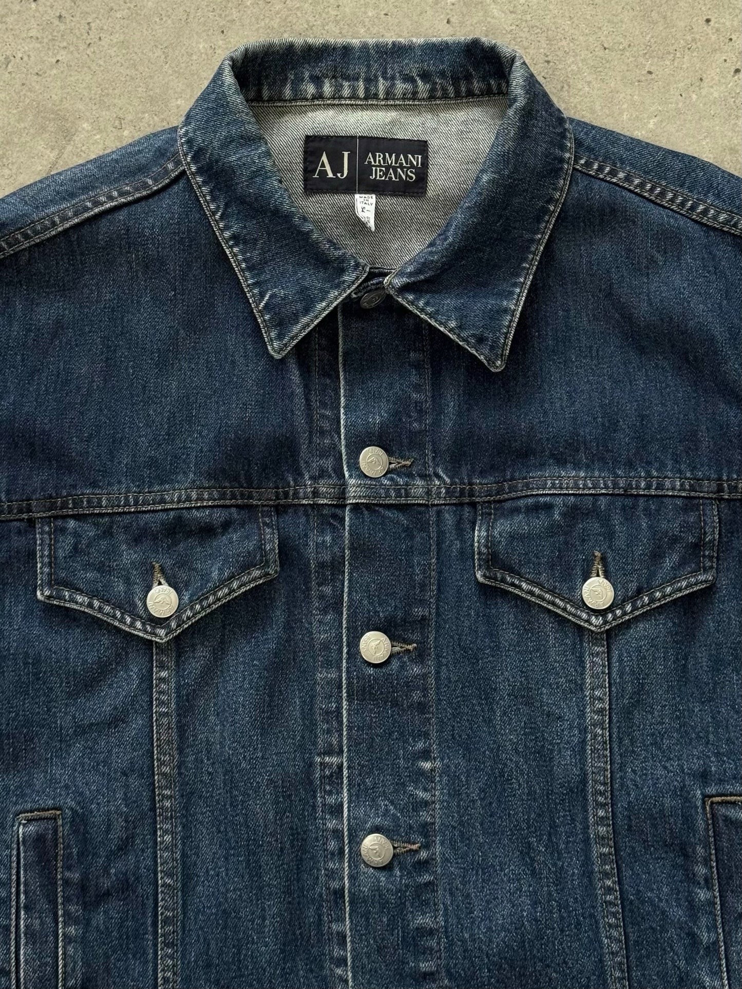 Armani Jeans 1990s pure cotton denim jacket shown with classic blue wash, button-front, and traditional collar, casual and stylish.
