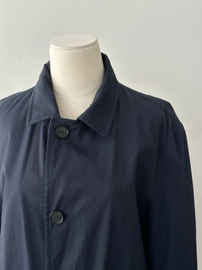 Hugo Boss 2000s cotton water-repellent trench coat in size L, shown hanging with a classic beige design and button details.