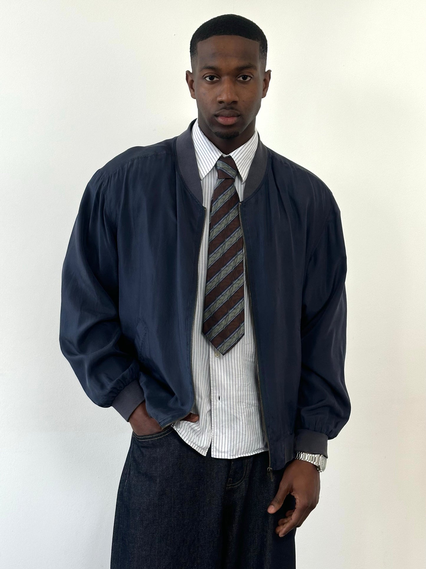 Vintage 1990s pure silk boxy bomber jacket in navy blue, featuring a classic fit and ribbed collar and cuffs.