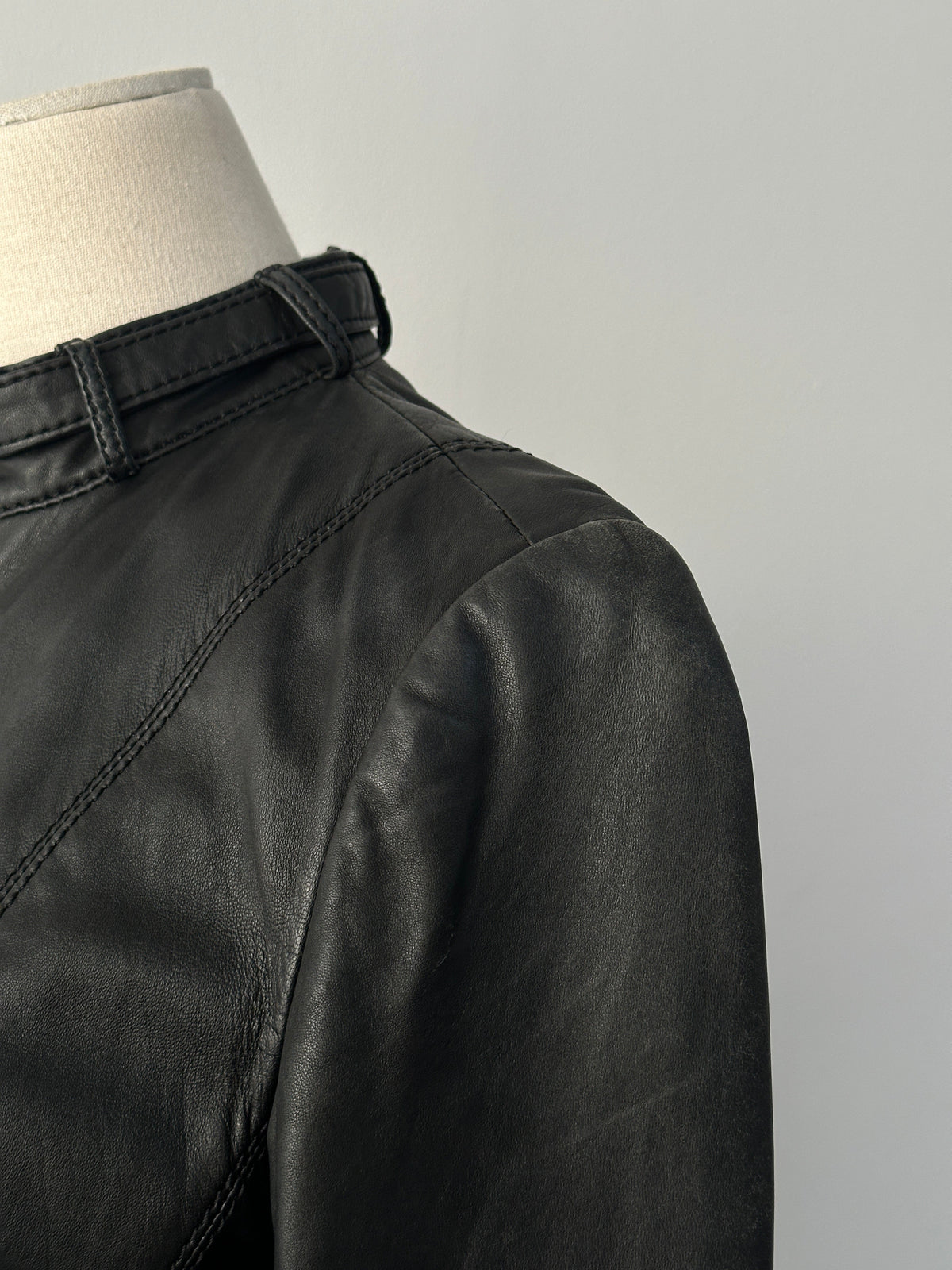 Vintage 2000s fitted leather moto jacket in lamb leather, size XS, with classic collar and zipper details.