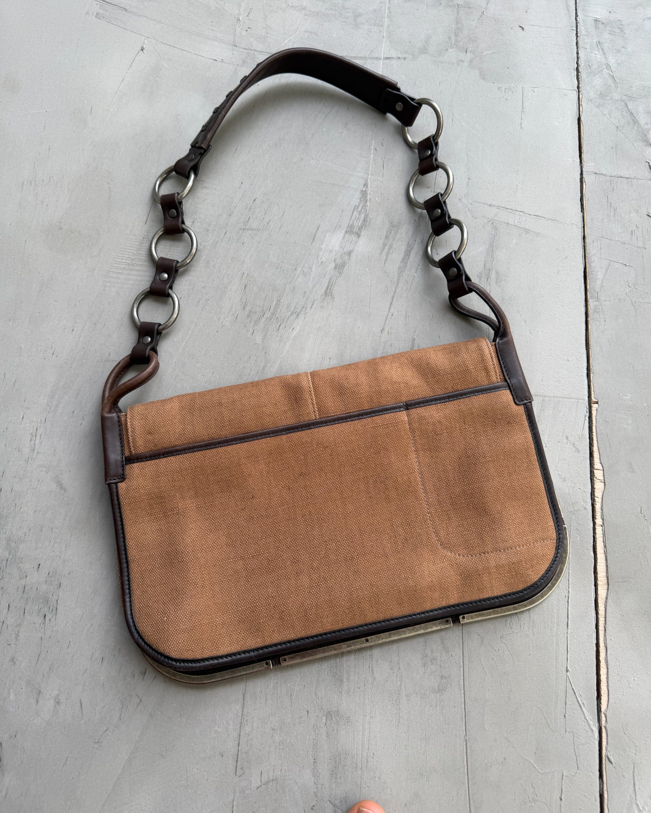 Yves Saint Laurent Brown Canvas Shoulder Bag-on a concrete background