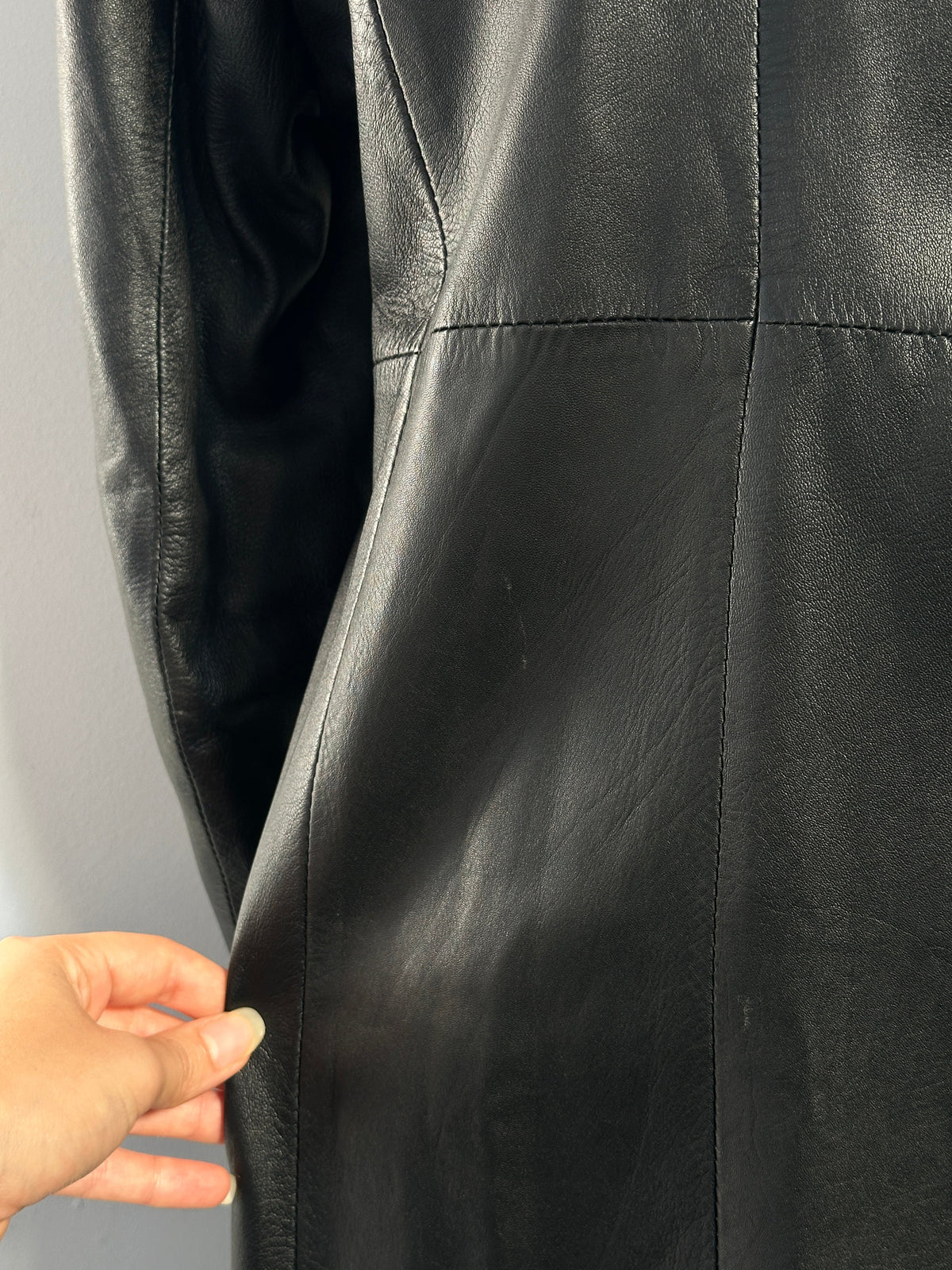 Vintage 1990s floor length leather trench coat, size small, with classic collar and long sleeves, black leather material.