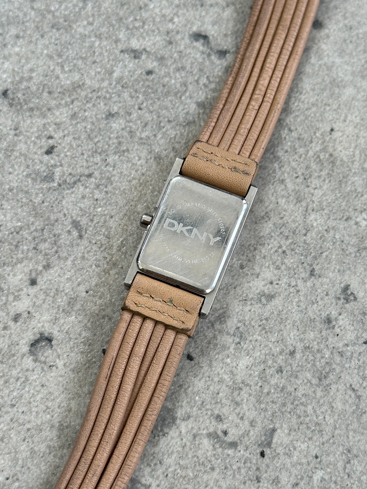 Donna Karran DKNY leather rectangular quartz watch with a classic design, featuring a black strap and silver-tone dial.